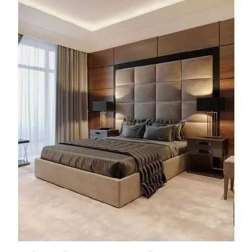 Bedroom with a full-height upholstered headboard wall