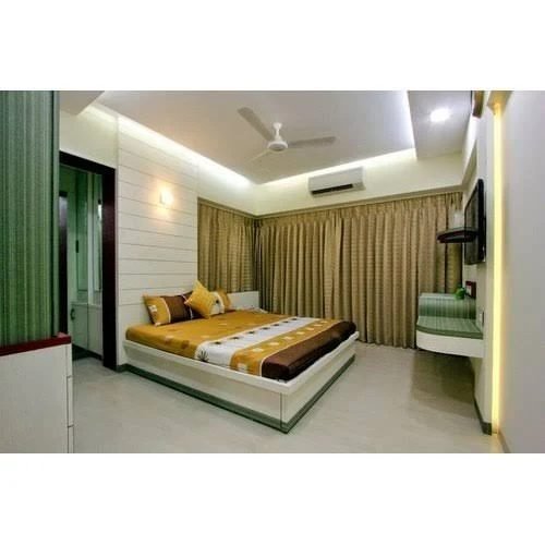 Bedroom with a false ceiling, floor-length drapes and a platform bed